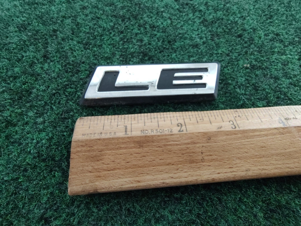 1984-1992 DODGE CARAVAN PLYMOUTH VOYAGER LE REAR LID EMBLEM LOGO BADGE OEM 5S5