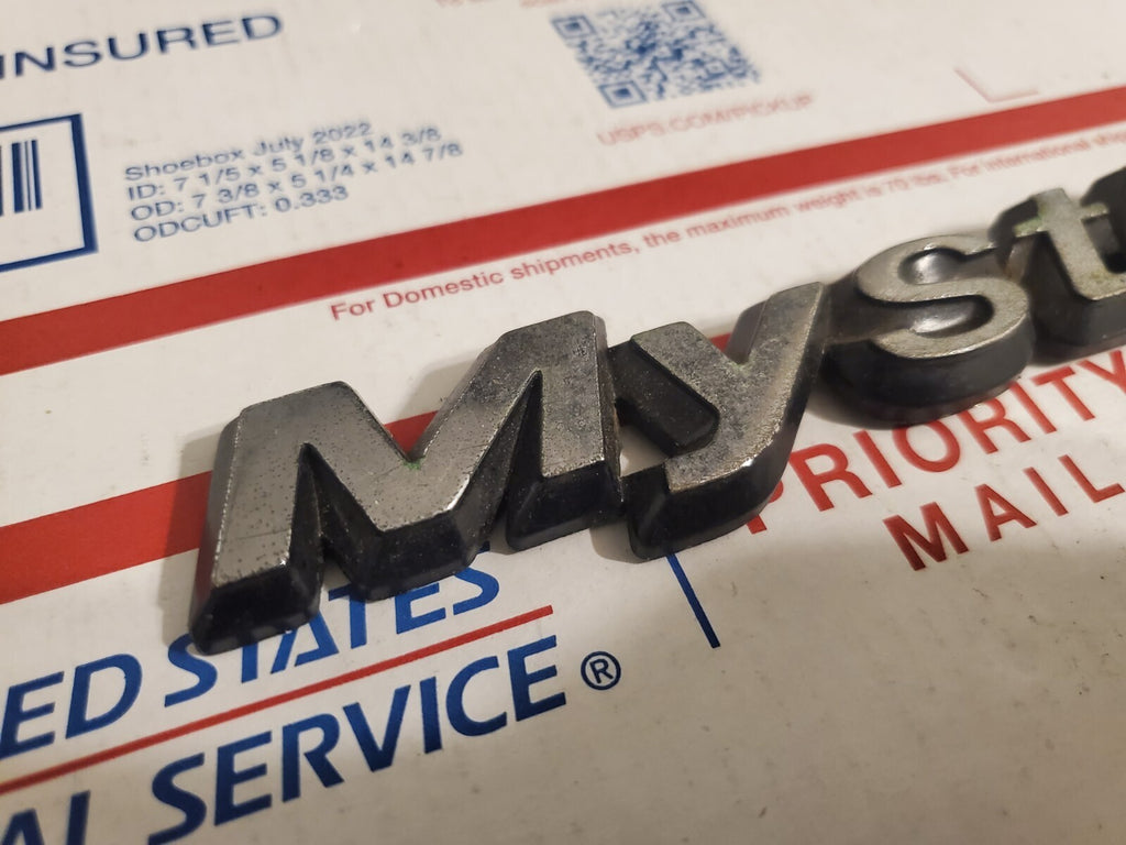 95 96 97 98 99 00 MERCURY MYSTIQUE REAR EMBLEM LOGO BADGE SIGN SYMBOL OEM 4L9
