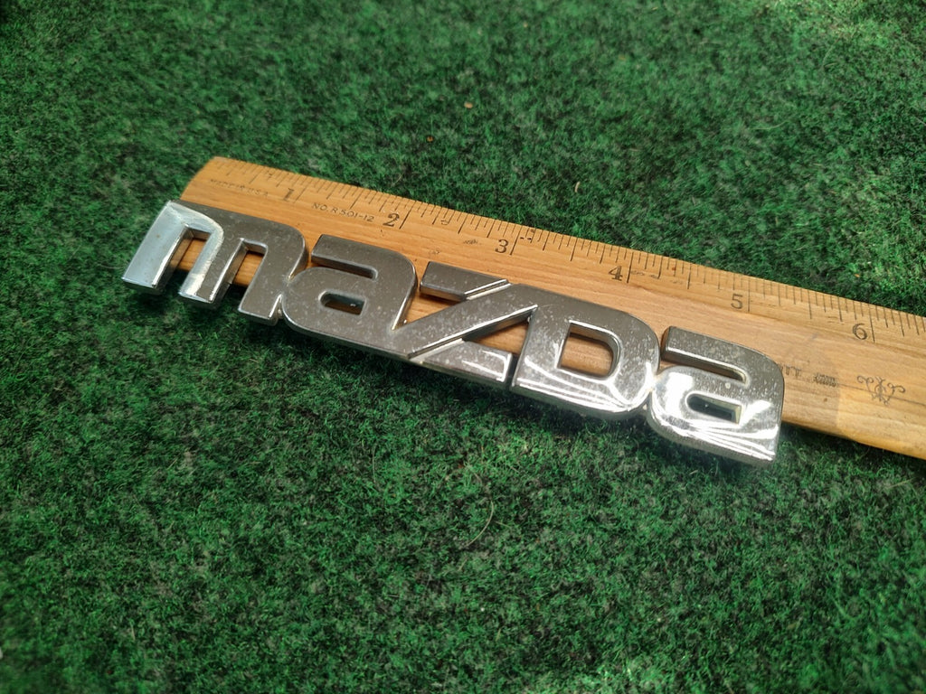 2002-2003 Mazda Protege 5 Rear Emblem Ornament Maker Name B25R-51-710 OEM 3S8