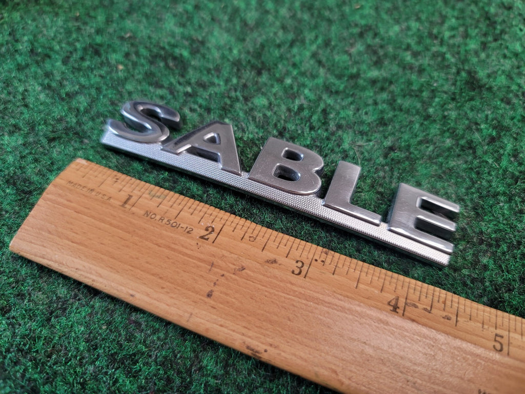 00 01 02 03 MERCURY SABLE REAR GATE LID EMBLEM BADGE SYMBOL LOGO OEM 2M4
