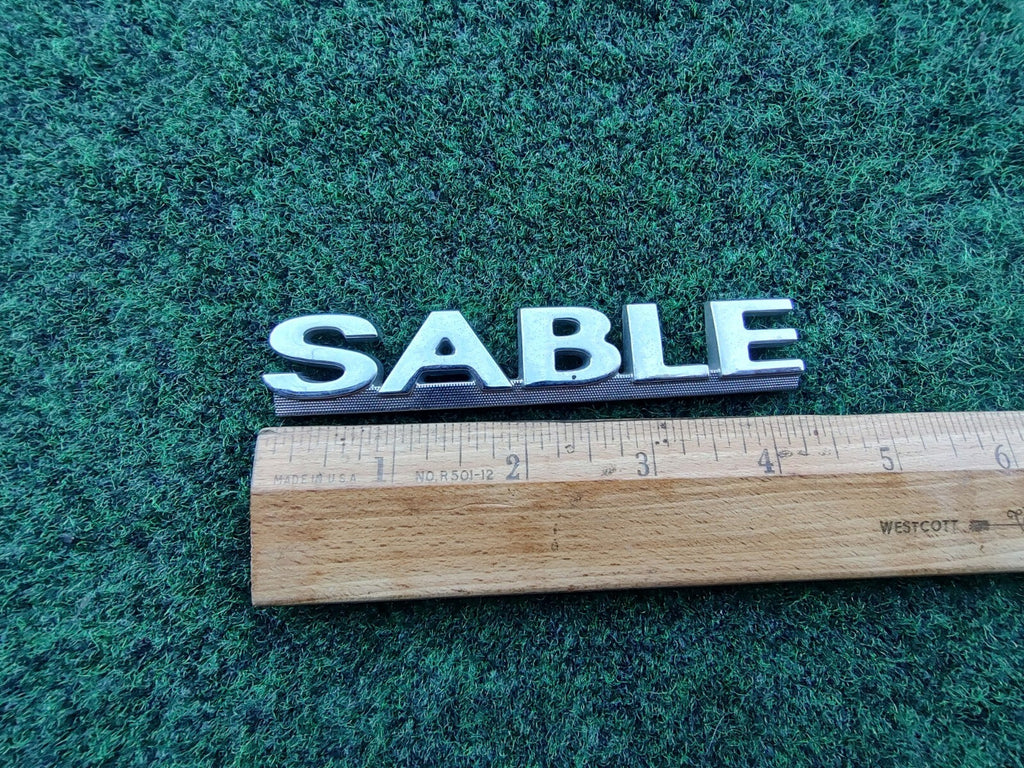00 01 02 03 MERCURY SABLE REAR GATE LID EMBLEM BADGE SYMBOL LOGO OEM 10L4