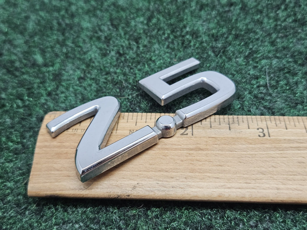 NISSAN 2.5 REAR CHROME EMBLEM LOGO SYMBOL BADGE OEM 7S7