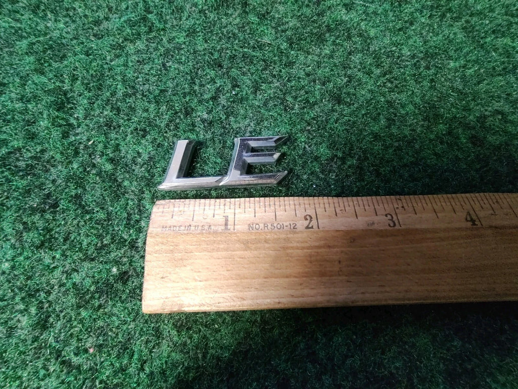 Genuine Toyota Camry "LE" Emblem USED 2002-2006  Rear 75443-AA100 8L2